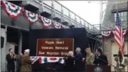  ?? MID-HUDSON NEWS NETWORK ?? A sign bearing the ceremonial new name of the Bear Mountain Bridge is unveiled on Monday alongside the Hudson River span.