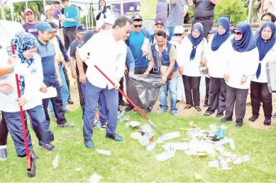  ??  ?? RASMI.. Datuk Dr Jaujan Sambakong menyempurn­akan simbolik perasmian Program Gotong-Royong Perdana di Semporna pada Ahad.