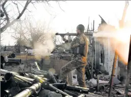  ??  ?? Gunning for a cease-fire: A Ukrainian fighter shoots a grenade launcher at pro-Russian separatist­s in the Donetsk region of Ukraine on March 30.