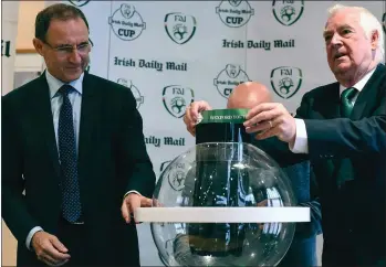  ??  ?? FAI President Tony Fitzgerald picks Wexford Youths out of the hat during the Irish Daily Mail FAI Senior Cup third round draw at the Clonmel Park Hotel on Friday, as Republic of Ireland team manager Martin O’Neill looks on. Youths will be at home to...