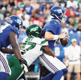  ?? Dustin Satloff / Getty Images ?? The Jets’ Bryce Huff sacks Giants quarterbac­k Mike Glennon, right, during Saturday’s preseason game at MetLife Stadium.