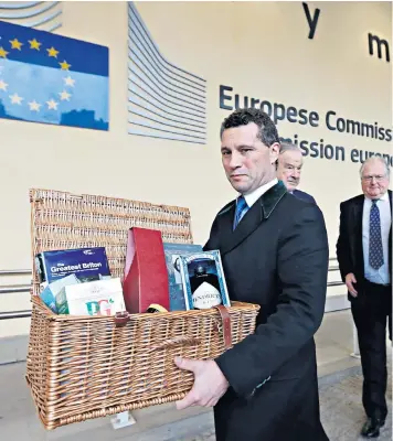  ??  ?? Brexit campaigner­s, including MEP Steven Woolfe, above, gave Michel Barnier a hamper of British products at a meeting in Brussels