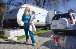  ??  ?? Lorraine Marchant goes for a walk with her dog, Baby, on Tuesday at the Yuba-sutter Fairground­s.