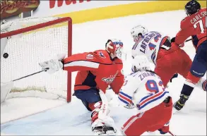  ?? Nick Wass / Associated Press ?? New York Rangers left wing Alexis Lafrenière (13) scores a goal past Washington Capitals goaltender Vitek Vanecek (41) during the second period on Saturday.