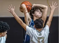  ?? JIM WEBER/THE NEW MEXICAN ?? Santa Fe Prep’s Mitch Grover looks for an open man under pressure by Mesa Vista guard Andres Valdez on Friday during a semifinal in Santa Fe Indian School’s Braves Invite.