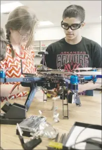  ?? ANGELA SPENCER/THREE RIVERS EDITION ?? Sophia Totten, left, and Madison Burke work on an unmanned aerial vehicle (UAV) in Chad Mercado’s class at Beebe High School.