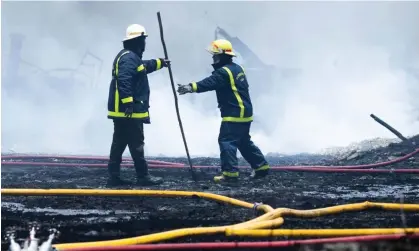  ?? Photograph: Yamil Lage/AP ?? Firefighte­rs work to put out a deadly firein Matanzas, Cuba, on 9 August.