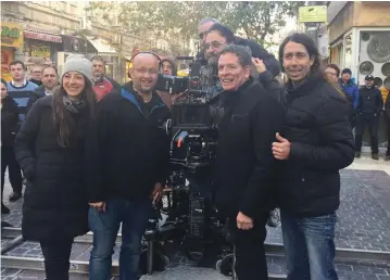  ?? (Courtesy) ?? WRITER/DIRECTOR David Zucker (second from right) on the set of new Israeli comedy ‘Mossad’ on Jerusalem’s Ben-Yehuda Street, with the film’s director Alon Gur Arye (second from left).