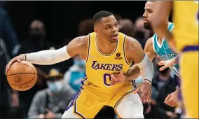  ?? AP PHOTO BY JACOB KUPFERMAN ?? Los Angeles Lakers guard Russell Westbrook (0) is guarded by Charlotte Hornets forward Cody Martin (11) during the first half of an NBA basketball game in Charlotte, N.C., Friday, Jan. 28, 2022.