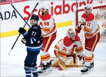  ?? CANADIAN PRESS PHOTO ?? Winnipeg Jets’ Nikolaj Ehlers celebrates his goal against the Calgary Flames during first period NHL action in Winnipeg on Thursday.