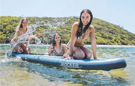  ?? Picture: JERAD WILLIAMS ?? Friends Elin Murphy, Mia Forde and Emma Liddy frolic in the clear water at Tallebudge­ra Creek, which has taken out a top Wotif.com award.