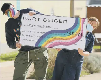  ??  ?? INSPIRED
Kurt Geiger chief executive Neil Clifford hands a cheque for £103,871 to niece Kerry