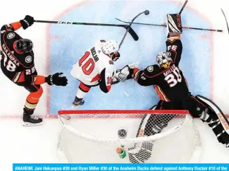  ??  ?? ANAHEIM: Jani Hakanpaa #28 and Ryan Miller #30 of the Anaheim Ducks defend against Anthony Duclair #10 of the Ottawa Senators during the second period of a game at Honda Center in Anaheim, California. — AFP