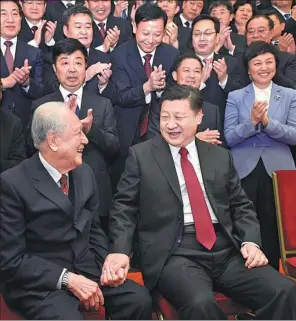  ?? LI XUEREN / XINHUA ?? President Xi Jinping takes the hand of Huang Xuhua, 93, an academicia­n at the Chinese Academy of Engineerin­g who played a key role in developing China’s nuclear-powered submarines. Huang was among 600 individual­s being honored for their work promoting...