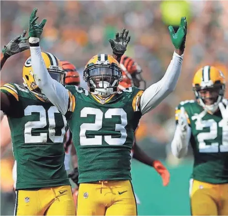  ?? DAN POWERS/USA TODAY NETWORK-WISCONSIN ?? Packers Damarious Randall (23), Kevin King (20) and Ha Ha Clinton-Dix celebrate Randall stopping Bengals running back Joe Mixon for a loss Sunday at Lambeau Field.