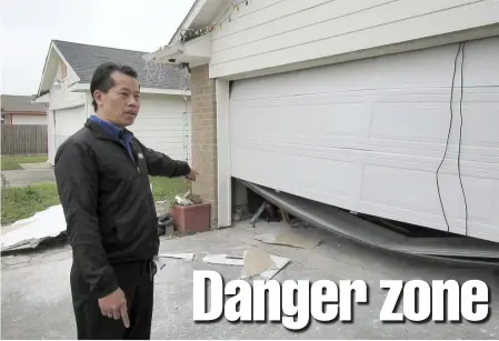  ?? AP FILE ?? SAFETY ISSUE: Houston resident Quan Nguyen talks about the damage, including a twisted garage door, his home sustained from the Jan. 24 explosion at a nearby industrial business.