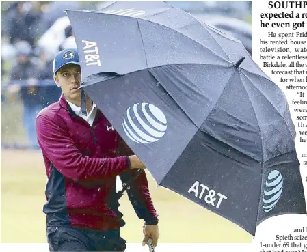 ?? AP ?? Jordan Spieth of the US walks along the 18th fairway and shelters from the rain during the second round of the British Open at Royal Birkdale, Southport, England.