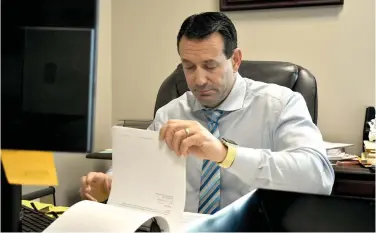  ?? (Pine Bluff Commercial/I.C. Murrell) ?? Outgoing Jefferson County Chief Deputy Prosecutin­g Attorney Will Jones reads through a document in his office Wednesday.