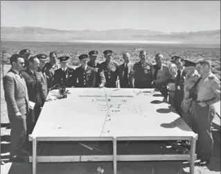  ?? COURTESY OF THE LUCHAK FAMILY ?? George Luchak, on far left wearing sunglasses, represente­d Canada at a briefing on an atomic bomb test by the United States in the Nevada desert in 1955.