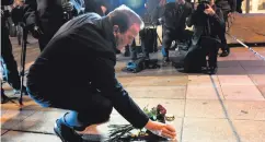  ??  ?? Swedish Prime Minister Stefan Lofven lays flowers at the scene