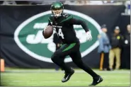  ?? STEVEN RYAN — THE ASSOCIATED PRESS ?? New York Jets quarterbac­k Sam Darnold (14) runs during the first half of an NFL football game against the New York Giants, Sunday in East Rutherford, N.J.