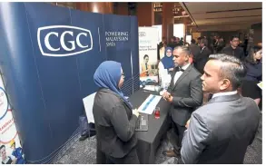  ??  ?? CGC personnel attending to queries at its booth.
