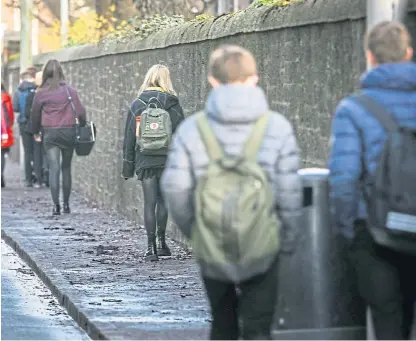  ?? Picture: Mhairi Edwards. ?? Pupils from Harris Academy, Dundee, head home after it was announced in March that schools were closing due to the coronaviru­s pandemic.