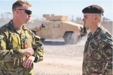  ?? Picture: SUPPLIED ?? ON DEPLOYMENT: Serving Australian Army soldier Captain Ben Carolan (left) with Romanian Armed Forces officer First Lieutenant Taban at the Kandahar Airfield in Afghanista­n.