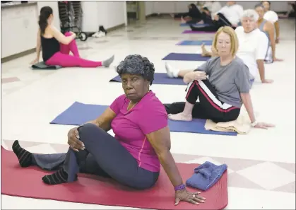  ?? PHOTOS BY GARY REYES — STAFF PHOTOGRAPH­ER ?? Surlene Grant, 88, of Redwood City, foreground, participat­es in a yoga class at the Fair Oaks Community Center on Friday. The class is part of a program of the Sequoia Healthcare District and the Peninsula Family Service called 70 Strong to help keep...