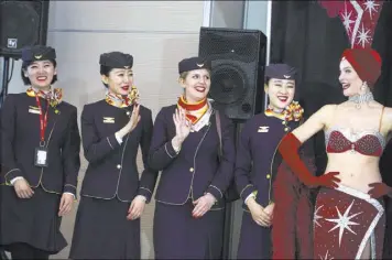  ?? JEFF SCHEID/LAS VEGAS REVIEW-JOURNAL FOLLOW @JEFFSCHEID ?? Flight attendants from Hainan Airlines wave Dec. 2 during a inaugural flight reception at McCarran Internatio­nal Airport.