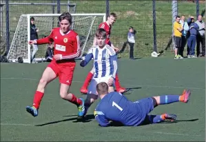  ??  ?? Pupils’ keeper Archie McKellar dives to save a goal.