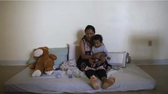  ?? MARTA IWANEK PHOTOS/TORONTO STAR ?? Yordanos Gebreab and her daughter, Gidena, sometimes sleep on a mattress on the living room floor to avoid what smells like marijuana wafting into their apartment.