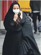  ?? EPA ?? A woman walks through Tehran. More than 250 people have tested positive for the virus across Iran, with the outbreak killing 26 people