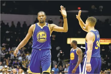  ?? DENIS POROY/ASSOCIATED PRESS ?? Warriors stars Kevin Durant, left, and Stephen Curry help make up a roster that blends last year’s talent with key additions.