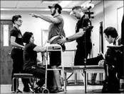  ?? TERESA CRAWFORD/AP ?? Jered Chinnock, injured in a snowmobile accident, stands with the assistance of his therapy team in Rochester, Minn.