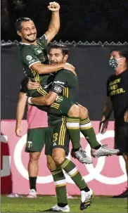  ?? JOHN RAOUX/ASSOCIATED PRESS ?? Portland Timbers midfielder Sebastian Blanco, top, celebrates his goal with Diego Valeri against the Philadelph­ia Union during the second half of an MLS soccer match, Wednesday.