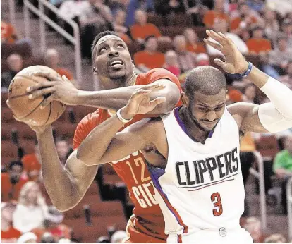  ?? Karen Warren photos / Houston Chronicle ?? Rockets center Dwight Howard, left, tries to find some elbow room against Clippers guard Chris Paul during the first half of Wednesday night’s game at Toyota Center. Howard didn’t find much, scoring only six points.