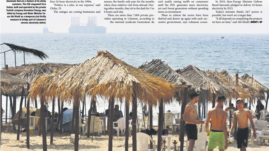  ??  ?? This Monday, July 16, 2018, photo shows people at the beach as a floating power station waits off the coast at Jiyeh, south of Beirut, Lebanon. Lebanon received a floating power station from Turkey this week to ease the rolling blackouts that are a...