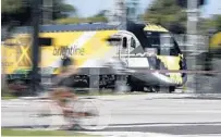  ?? BRYNN ANDERSON/AP ?? A Brightline passenger train passes Oakland Park in November.