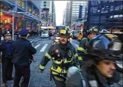  ?? DAVID SCULL / THE NEW YORK TIMES ?? Police and firefighte­rs on Eighth Avenue in New York following an explosion on Monday morning. The explosion caused the authoritie­s to evacuate one of the busiest transit hubs in the city.