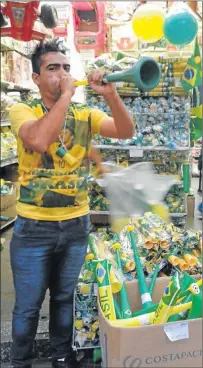  ?? Picture: LAURA BROWN ?? HAVING A BLAST: A Brazilian man blows a vuvuzela as Fifa World Cup fever finally sets in in the soccer-loving country