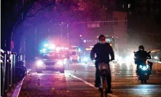  ?? AFP PHOTO ?? HIGH ALERT
Police vehicles are seen on one side of a street in China’s capital Beijing on Monday, Nov. 28, 2022.