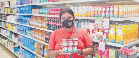  ?? Picture: SUPPLIED ?? Aysa Narayan of Nadroga Sangam School compound at True Mart in Yadua, Sigatoka with packets of Marigold — perfect for quenching your thirst.