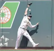  ?? TONY AVELAR — THE ASSOCIATED PRESS ?? A’s left fielder Seth Brown can’t make the catch on a double by the Indians’ Cesar Hernandez in the fifth inning Saturday.