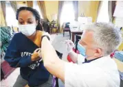  ?? AP PHOTO/ ROGELIO V. SOLIS ?? Walgreens pharmacist Chris McLaurin prepares to vaccinate Lakandra McNealy, a Harmony Court Assisted Living employee, with the Pfizer-BioNTech COVID-19 vaccine, on Tuesday in Jackson, Miss.