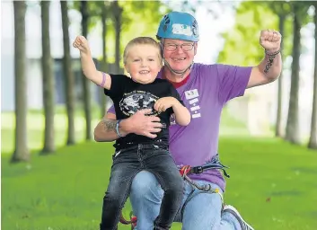  ??  ?? Reaching new heights David after he completed the 150ft zipslide with his proud son Jack