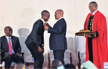  ?? Picture: OUPA MOKOENA ?? EXCELLENCE: Siyabulela Xuza receives an award from President Jacob Zuma during the 2017 National Orders Awards in Pretoria last week.