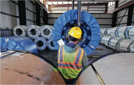  ?? Eric Gay / Associated Press file ?? A worker uses a lift to move rolls of sheet metal at LMS Internatio­nal in Laredo. Changes to NAFTA would directly affect Texas.