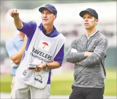  ?? Catherine Avalone / Hearst Connecticu­t Media ?? Paul Casey maps out the 16th hole with his caddy, John McLaren, during the third round of the Travelers Championsh­ip on Saturday in Cromwell.