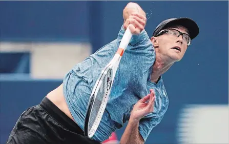  ?? CANADIAN PRESS FILE PHOTO ?? Peter Polansky serves to Novak Djokovic of Serbia during second-round men's Rogers Cup tennis tournament action in Toronto on Aug. 8. Polansky is the luckiest loser in tennis this season, receiving a main-draw entry into each of the past three Grand Slams despite losing his final qualifier.